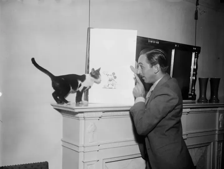 Walt Disney with his most famous creation — a drawing of Mickey Mouse