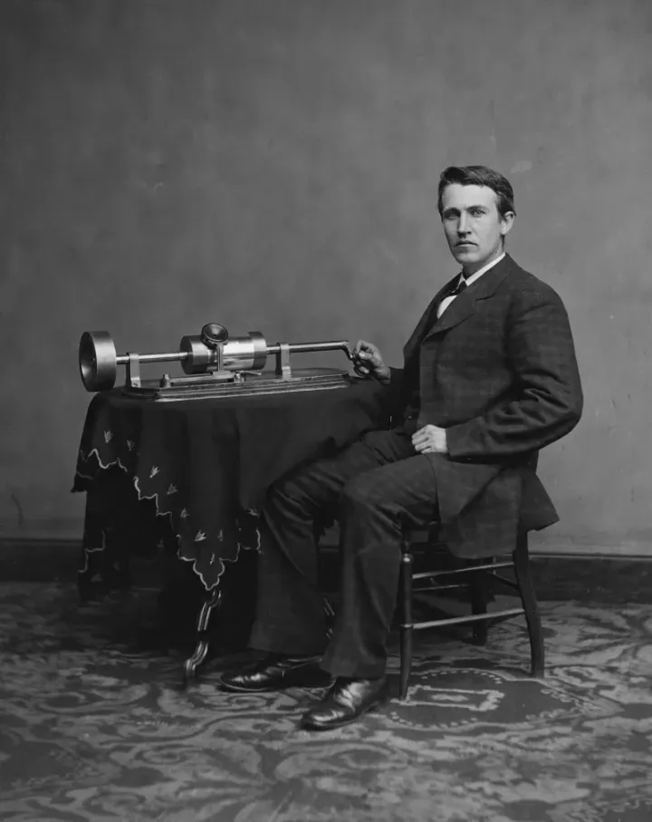 Thomas Edison seated with his phonograph invention, 1878